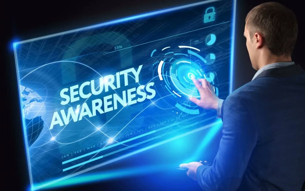 Employee at a computer screen with a security awareness training interface overlay